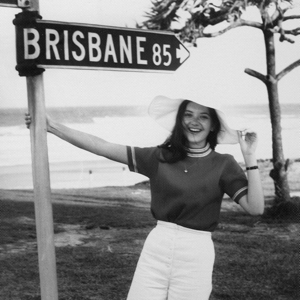 Photo of LYCON founder Lydia Jordane as a teenager holding street post that says Brisbane