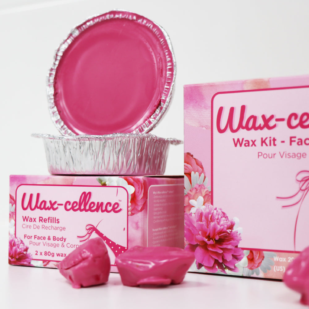 Photo of Wax-cellence Waxing Kit and wax refills with wax rocks in front